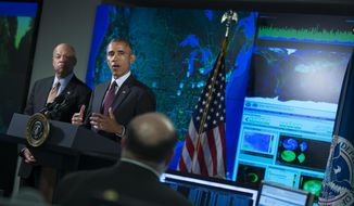 Homeland Security Secretary Jeh Johnson listens at left as President Barack Obama speaks at the National Cybersecurity and Communications Integration Center in Arlington, Va., Tuesday, Jan. 13, 2015. Obama renewed his call for Congress to pass cybersecurity legislation, including a proposal that encourages companies to share threat information with the government and protects them from potential lawsuits if they do. (AP Photo/Evan Vucci)