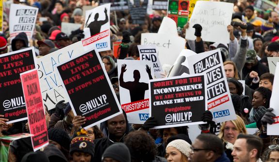 Demonstrators march on Pennsylvania Avenue toward Capitol Hill in Washington, Saturday, Dec. 13, 2014, during the Justice for All march. More than 10,000 protesters are converging on Washington in an effort to bring attention to the deaths of unarmed black men at the hands of police. Civil rights organizations are holding a march to the Capitol on Saturday with the families of Michael Brown and Eric Garner, two unarmed black men who died in incidents with white police officers. (AP Photo/Jose Luis Magana)