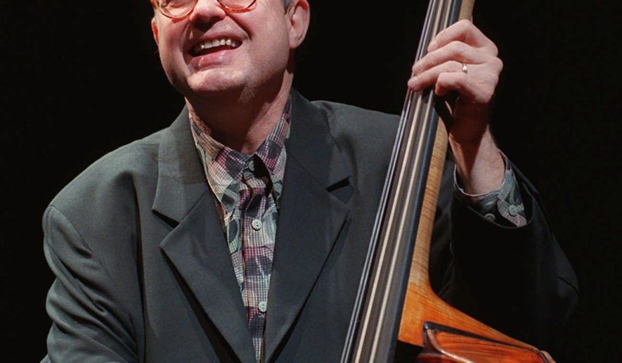 FILE - In this Jan. 9, 1997 file photo, Jazz bassist Charlie Haden laughs with bandmates during a soundcheck at the House of Blues in West Hollywood, Calif. Pat Metheny, Josh Redman and other jazz stars turned out for a memorial concert to celebrate the music and life of Haden, one of the most influential bassists in jazz history. Singer Ruth Cameron Haden, who hosted the gathering on Tuesday night, Jan. 13, 2015, at Town Hall, said her late husband made it his life mission "to impart and bring beauty to the world" through his music. (AP Photo/Chris Pizzello, File)