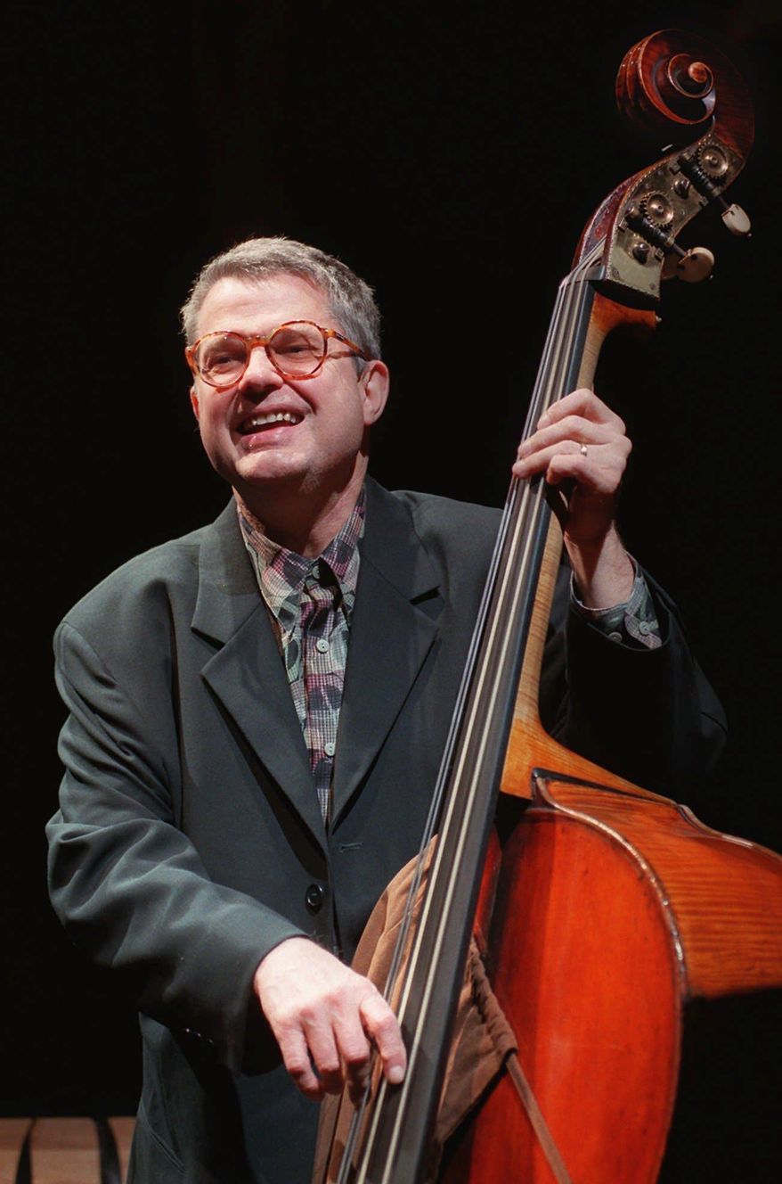 FILE - In this Jan. 9, 1997 file photo, Jazz bassist Charlie Haden laughs with bandmates during a soundcheck at the House of Blues in West Hollywood, Calif. Pat Metheny, Josh Redman and other jazz stars turned out for a memorial concert to celebrate the music and life of Haden, one of the most influential bassists in jazz history. Singer Ruth Cameron Haden, who hosted the gathering on Tuesday night, Jan. 13, 2015, at Town Hall, said her late husband made it his life mission "to impart and bring beauty to the world" through his music. (AP Photo/Chris Pizzello, File)
