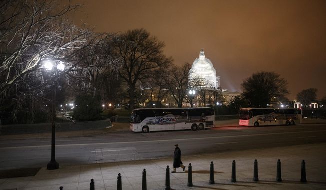 The U.S. Capitol in Washington is seen Wednesday evening, Jan. 14, 2015. A man who plotted to attack the U.S. congressional building and kill government officials inside it and spoke of his desire to support the Islamic State group was arrested on Wednesday, the FBI said. The Capitol Dome is covered with scaffolding for a long-term repair project.  (AP Photo/J. Scott Applewhite)