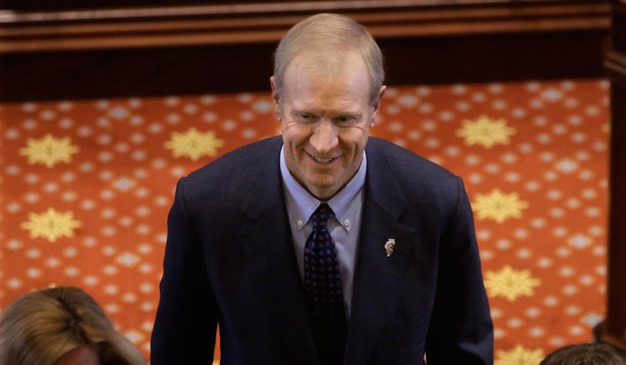 Illinois Gov. Bruce Rauner exits the floor during swearing-in ceremonies in the Senate chamber at the State Capitol, Wednesday, Jan. 14, 2015, in Springfield Ill. (AP Photo/Seth Perlman)