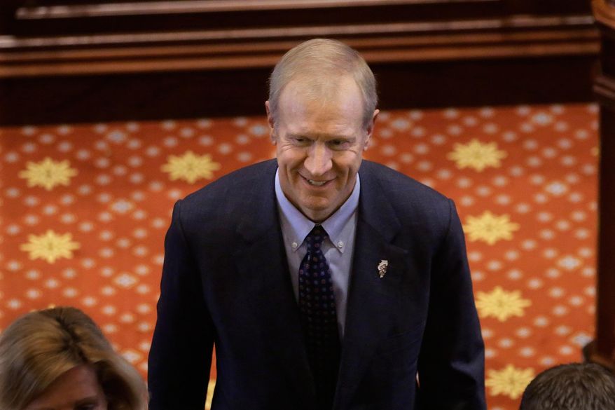 Illinois Gov. Bruce Rauner exits the floor during swearing-in ceremonies in the Senate chamber at the State Capitol, Wednesday, Jan. 14, 2015, in Springfield Ill. (AP Photo/Seth Perlman)