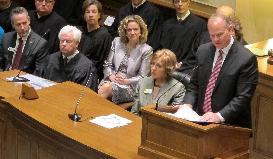 Wyoming Gov. Matt Mead, right, delivers his state of the state address on Wednesday, Jan. 14, 2015, at the state Capitol in Cheyenne, Wyo. He says the state of the state is strong and says it must continue to invest in its future. (AP Photo/Ben Neary)