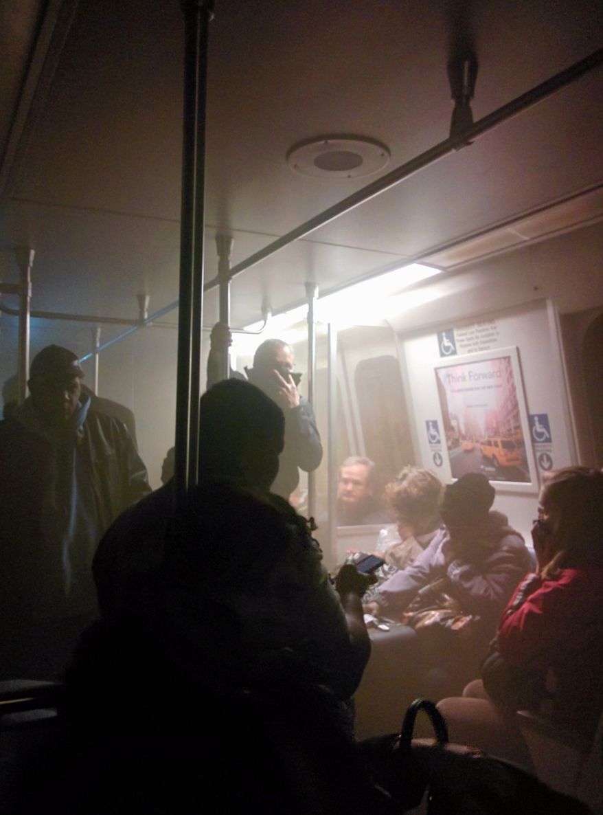Smoke fills a Washington Metro system subway car near the L&#39;Enfant Plaza station in Washington on Monday, Jan. 12, 2015. (AP Photo/Andrew Litwin)