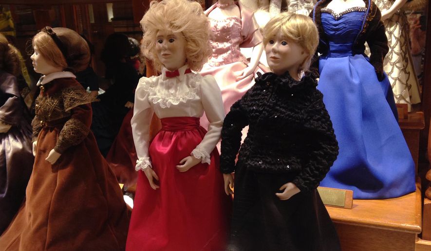 In this Jan. 14, 2015 photo are dolls wearing the 2011, right front, and 1983, center, inaugural gown of Iowa first lady Chris Branstad in a case displaying the gowns of first ladies in the Iowa State Capitol in Des Moines. While Chris Branstad has two dolls in the case, because Branstad has served two different stints in office, no new doll will be made to commemorate Branstad's sixth inauguration. A spokesman says the custom is to create a doll for the inauguration of a new governor, not for every inaugural ball. (AP Photo/Catherine Lucey)