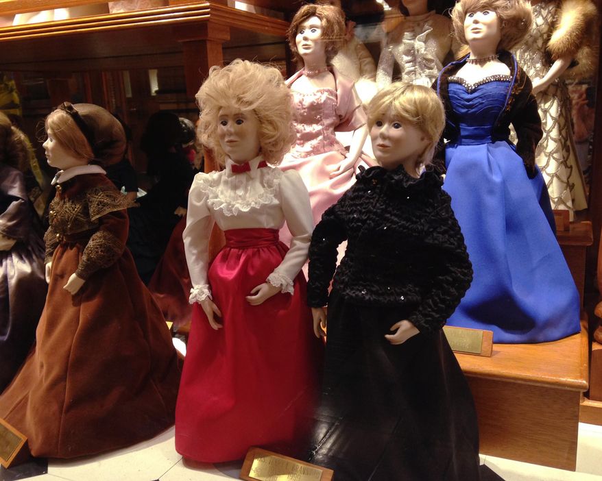 In this Jan. 14, 2015 photo are dolls wearing the 2011, right front, and 1983, center, inaugural gown of Iowa first lady Chris Branstad in a case displaying the gowns of first ladies in the Iowa State Capitol in Des Moines. While Chris Branstad has two dolls in the case, because Branstad has served two different stints in office, no new doll will be made to commemorate Branstad's sixth inauguration. A spokesman says the custom is to create a doll for the inauguration of a new governor, not for every inaugural ball. (AP Photo/Catherine Lucey)