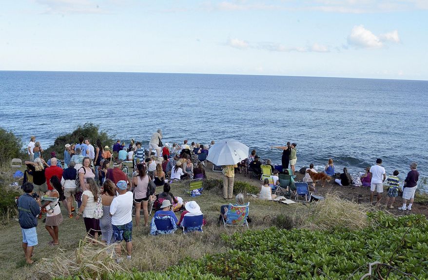 ADVANCE FOR RELEASE SUNDAY, JAN. 18, AND THEREAFTER - In this Jan. 11, 2015 photo, a crowd gathers at Kealia lookout for Sunday’s welcoming of the whales ceremony in Kapaa, Hawaii. The event, organized by Kohola Leo, which means voice of the whales, welcomes the return of the humpback whales from Alaska to spend the winter in Hawaii so they can breed and deliver their babies in warm tropical waters. (AP Photo/The Garden Island, Bill Buley)