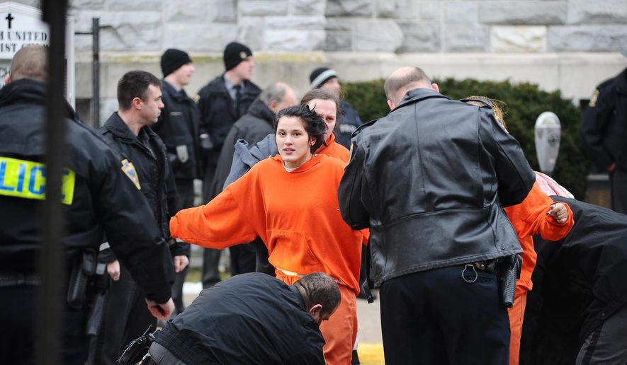An inmate is searched while being escorted from Northumberland County Prison in Sunbury, Pa., Wednesday, Jan. 14, 2015. Dispatchers say the blaze was reported just after 2 p.m. at the nearly 140-year-old jail in the city of 10,000 about 40 miles north of Harrisburg, Pa. (AP Photo/The News-Item, Larry Deklinski)