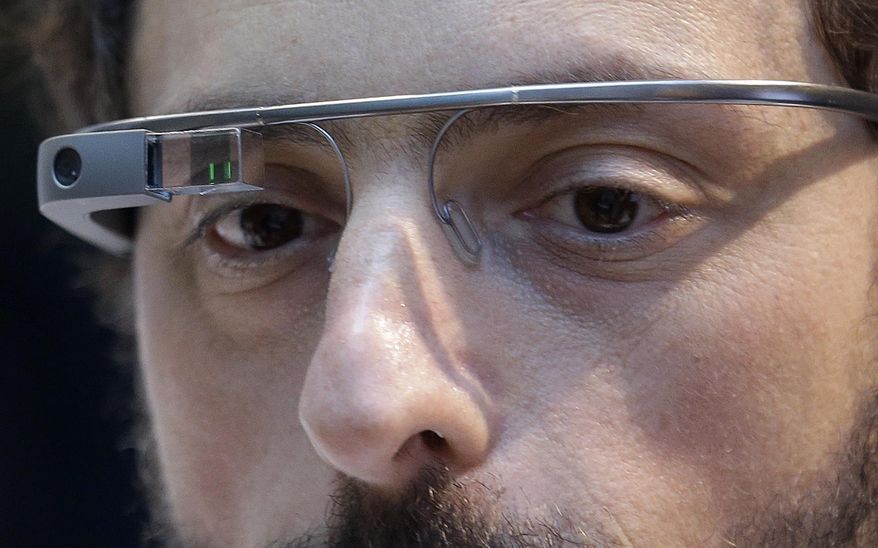 FILE - In this Feb. 20 2013 file photo, Google co-founder Sergey Brin wears a Google Glass device in San Francisco. Google on Thursday, Jan. 15, 2015 announced it will stop selling its Internet-connected eyewear to consumers until the company can develop a more polished and affordable version that's less likely to be viewed as a freakish device. (AP Photo/Jeff Chiu, File)