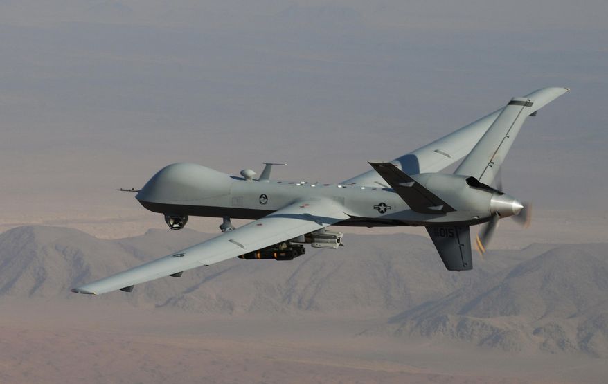 In this undated handout file photo provided by the U.S. Air Force, a MQ-9 Reaper, armed with GBU-12 Paveway II laser guided munitions and AGM-114 Hellfire missiles, is piloted by Col. Lex Turner during a combat mission over southern Afghanistan. (AP Photo/Lt. Col.. Leslie Pratt, US Air Force, File)