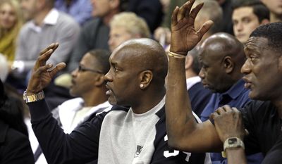Former Seattle SuperSonics&#x27; player Gary Payton, left, and former teammate Shawn Kemp motion as the two watch their sons, Oregon State&#x27;s Gary Payton II and Washington&#x27;s Shawn Kemp Jr., in the first half of an NCAA college basketball game Thursday, Jan. 15, 2015, in Seattle.(AP Photo/Elaine Thompson)