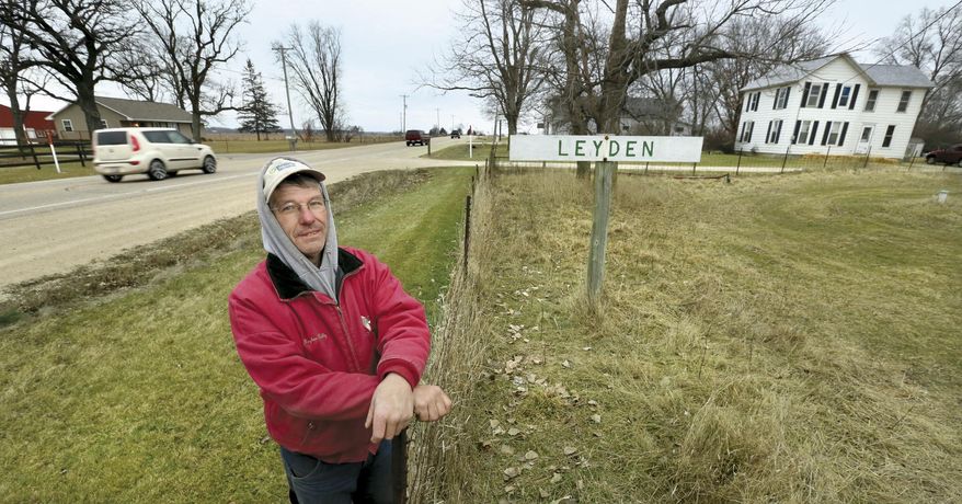 ADVANCE FOR WEEKEND EDITIONS JAN. 18-19 - In this photo taken Dec. 17, 2014, Gaylen Reilly, who has lived his entire life within a half mile of the tiny Rock County community known as Leyden, Wis., poses for a photo. Although never incorporated, Leyden had a railroad depot, a creamery, general store and more. Now most people just drive by the tiny collection of homes on highwat 14, unaware of the history. (AP Photo/The Janesville Gazette, Bill Olmsted)