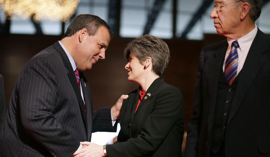 New Jersey Gov. Chris Christie, left, greets U.S. Sen. Joni Ernst, R-Iowa, and U.S. Sen. Charles Grassley, R-Iowa, right, during Iowa Gov. Terry Branstad's inauguration ceremonies, Friday, Jan. 16, 2015, in Des Moines, Iowa. (AP Photo/Charlie Neibergall)