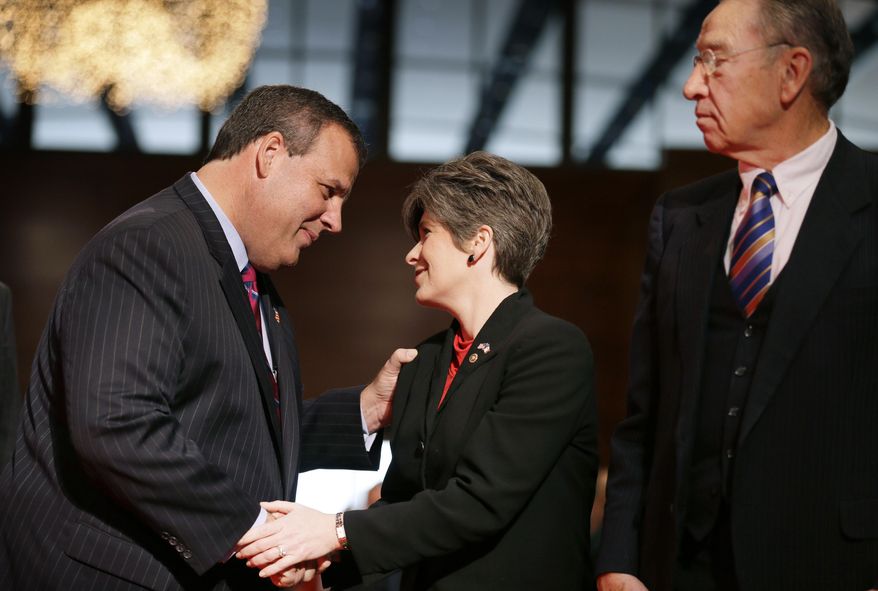 New Jersey Gov. Chris Christie, left, greets U.S. Sen. Joni Ernst, R-Iowa, and U.S. Sen. Charles Grassley, R-Iowa, right, during Iowa Gov. Terry Branstad's inauguration ceremonies, Friday, Jan. 16, 2015, in Des Moines, Iowa. (AP Photo/Charlie Neibergall)