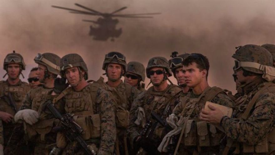 Marine Infantry Officer Course students await a CH-53E Super Stallion helicopter fast rope drill on the Marine Corps Air Station Yuma, Ariz., Auxiliary Landing Field 2, Wednesday, August 18, 2014. (U.S. Marine Corps) FILE **