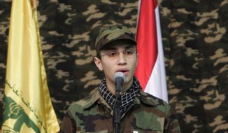In this picture taken on Feb., 22, 2008, Jihad Mughniyeh, the son of slain top Hezbollah commander Imad Mughniyeh, speaks during a rally to commemorate his father and two other leaders Abbas Musawi and Ragheb Harb, in the Shiite suburb of Beirut, Lebanon. A Hezbollah official said Sunday, Jan. 18, 2015, that an Israeli strike in the Syrian Golan Heights killed Jihad Mughniyeh and four other fighters from the Lebanese Shiite militant group. (AP Photo/Hussein Malla)