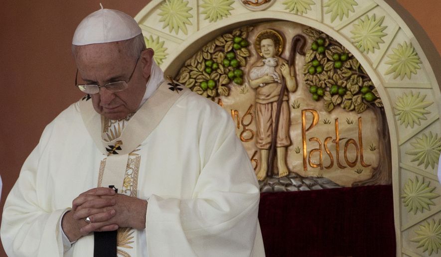 Pope Francis prays during a Mass at Rizal Park in Manila, Philippines, Sunday, Jan. 18, 2015. Millions filled Manila&#39;s main park and surrounding areas for Francis&#39; final Mass in the Philippines on Sunday, braving a steady rain to hear the pontiff&#39;s message of hope and consolation for the Southeast Asian country&#39;s most downtrodden and destitute. (AP Photo/Alessandra Tarantino)
