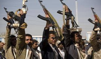 Houthi Shiite Yemeni raise their weapons during clashes near the presidential palace in Sanaa, Yemen, Monday, Jan. 19, 2015. Rebel Shiite Houthis battled soldiers near Yemen&#39;s presidential palace and elsewhere across the capital Monday, despite a claim of a cease-fire being reached to halt the violence, witnesses and officials said. (AP Photo/Hani Mohammed)