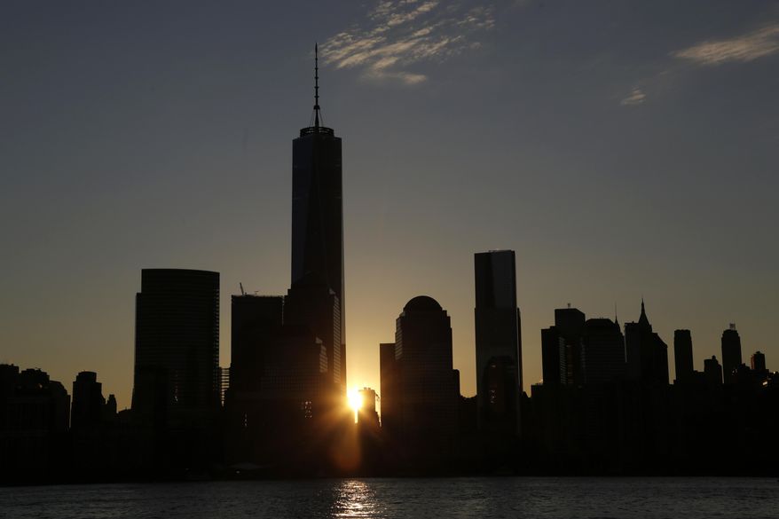 FILE - In this Nov. 3, 2014 file photo, the sun rises next to One World Trade Center in New York City. Democrats are weighing New York, Philadelphia or Columbus, Ohio, for its 2016 convention. Party officials are expected to make a final decision in late January or early February. (AP Photo/Mark Lennihan)