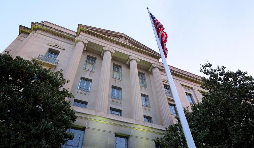 The Department of Justice headquarters building in Washington is seen here on May 14, 2013. (Associated Press) **FILE** 