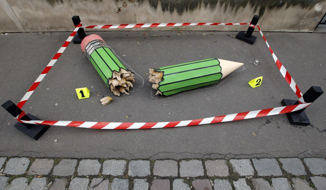 An anonymous art installation showing a broken pencil is displayed on the pavement near the Charlie Hebdo office in Paris, Tuesday, Jan. 20, 2015. Terror attacks by French Islamic extremists should force the country to look inward at its &amp;quot;ethnic apartheid,&amp;quot; the prime minister said Tuesday as four men faced preliminary charges on suspicion of links to one of the gunmen. (AP Photo/Francois Mori)