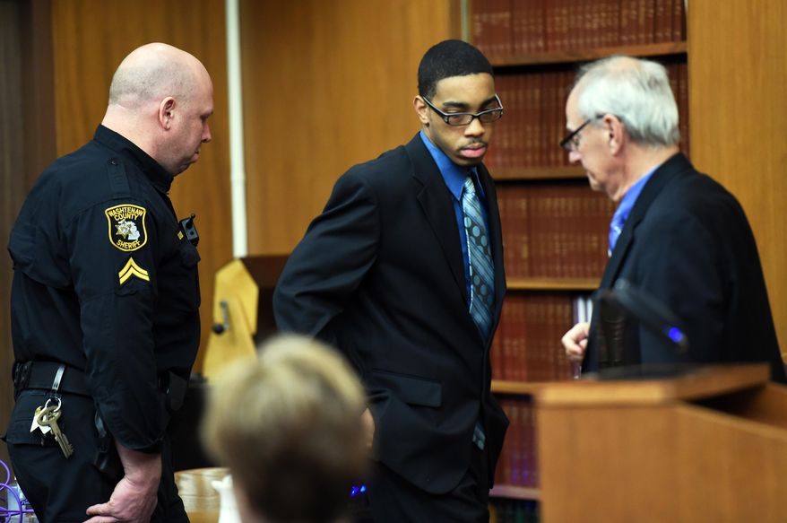 Joei Jordan, one of three defendants, is led into court for his his trial in the 2013 fatal shooting of University of Michigan medical student Paul DeWolf, Wednesday, Jan. 21, 2015 at the Washtenaw County Trial court in Ann Arbor, Mich. (AP Photo/The Ann Arbor News, Melanie Maxwell)