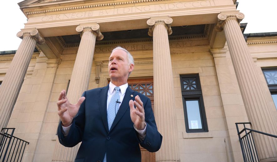 Wisconsin Republican Sen. Ron Johnson speaks on the steps of Wisconsin Eastern District Federal Courthouse in Green Bay, Wis., in this July 7, 2014, file photo. (AP Photo/The Green Bay Press-Gazette, Jim Matthews, File) NO SALES