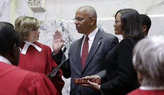 Boyd Rutherford, center, accompanied by his wife Monica, takes the oath of office from from Mary Ellen Barbera, Chief Judge of the Maryland Court of Appeals, to become the Lt. Gov. of Maryland inside the state senate chamber, Wednesday, Jan. 21, 2015, before an inauguration ceremony in Annapolis, Md. (AP Photo/Patrick Semansky, Pool)