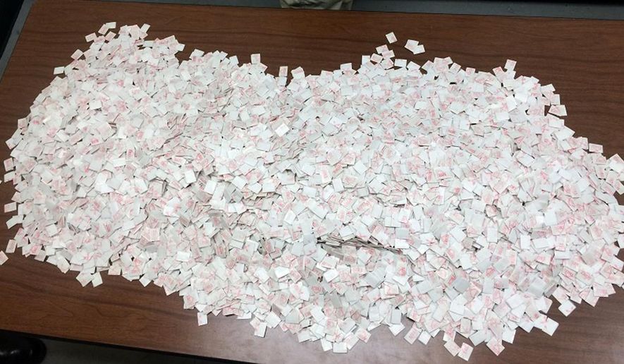 This photo taken Tuesday, Jan. 20, 2015, and provided by Delaware State Police shows what they say are 15,000 packets of heroin found in the car of Davon Tucker, of Paterson, N.J., during a traffic stop in Milton, Del. (Associated Press/Delaware State Police) **FILE**