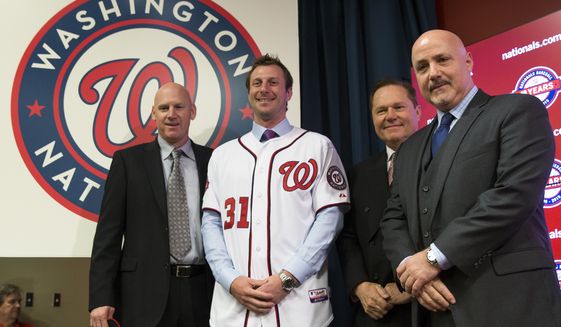 Washington Nationals pitcher Max Scherzer, second from left, poses for photographs during an introductory news conference at Nationals Park, on Wednesday, Jan. 21, 2015, in Washington. Scherzer signed a $210 million, seven- year contract to join the Nationals. From left, Nationals manager Matt Williams, Scherzer, Scherzer&#39;s agent Scott Boras, and Nationals general manager Mike Rizzo. (AP Photo/Evan Vucci)  