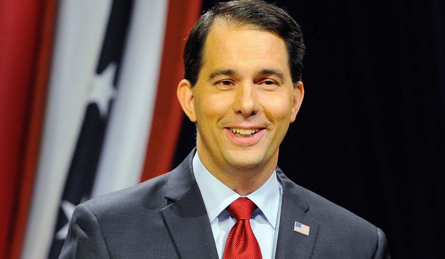 Wisconsin Republican Governor Scott Walker is one of 23 potential GOP presidential hopefuls heading to the Iowa Freedom Summit in Des Moines on Saturday to test their messages.  (Associated Press)
