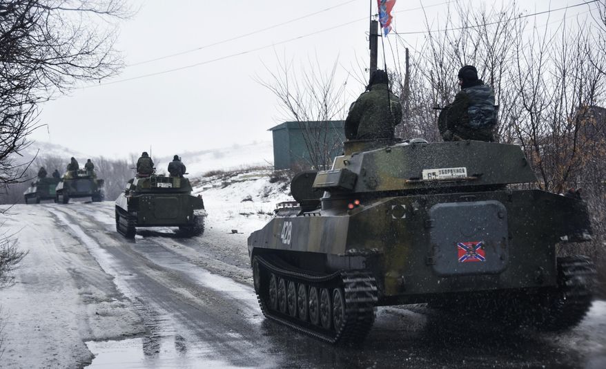 A pro-Russian armored vehicle moves toward Slovyanoserbsk, eastern Ukraine, Wednesday, Jan. 21, 2015. Moscow has proposed restoring a previously agreed line of division in eastern Ukraine to end an escalation of fighting near Donetsk, and has secured rebel agreement to pull back heavy weapons behind it, Russian foreign minister said Wednesday. (AP Photo/Mstyslav Chernov)