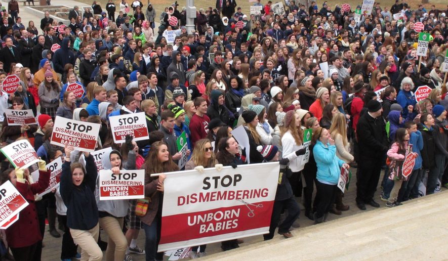 Hundreds of abortion opponents rally at the Kansas Statehouse, Thursday, Jan. 22, 2015, in Topeka, Kan. The rally was sponsored by Kansans for Life and marked the 42nd anniversary of the U.S. Supreme Court decision legalizing abortion across the nation. (AP Photo/John Hanna)