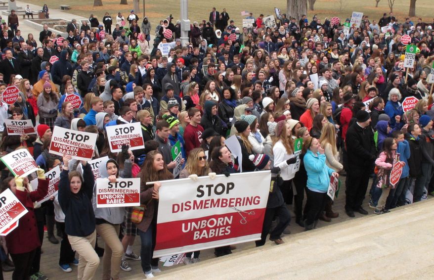 Hundreds of abortion opponents rally at the Kansas Statehouse, Thursday, Jan. 22, 2015, in Topeka, Kan. The rally was sponsored by Kansans for Life and marked the 42nd anniversary of the U.S. Supreme Court decision legalizing abortion across the nation. (AP Photo/John Hanna)