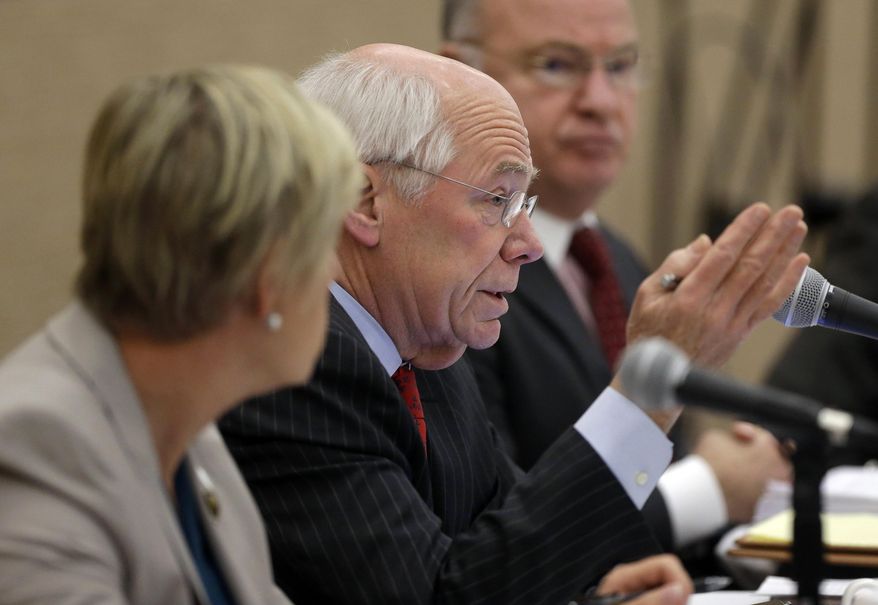 Massachusetts Gaming Commissioner James McHugh, center, speaks during a commission meeting as Gaming Commissioner Gayle Cameron, left, and state Gaming Commission Chair Stephen Crosby, right, look on, Thursday, Jan. 22, 2015, in Boston. Wynn Resorts unveils its proposed new designs for a casino in Everett, Mass., at the meeting. (AP Photo/Steven Senne)