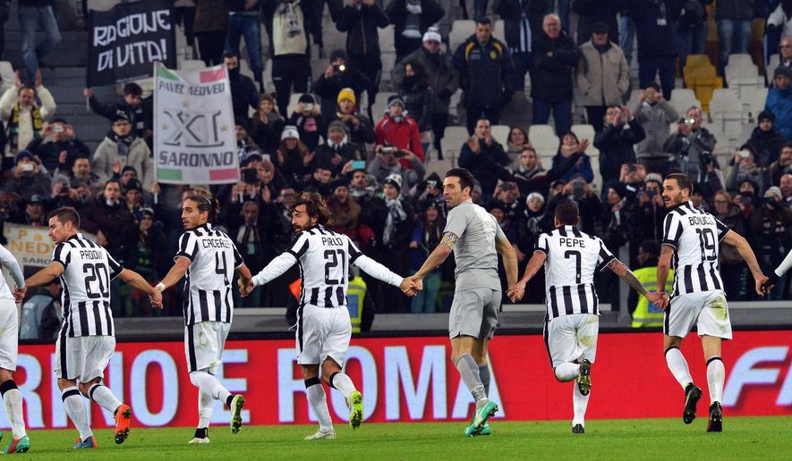 Juventus players celebrate at the end of a Serie A soccer match between Juventus and Hellas Verona at the Juventus stadium in Turin, Italy, Sunday, Jan. 18, 2015. (AP Photo/Alessandro Di Marco, Ansa)