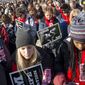 Lauren Sandy, 18, front left, and Afure Adah, 17, of Fargo, N.D., pray as they attend a pro-life rally at the annual March for Life, Thursday, Jan. 22, 2015, on the National Mall in Washington before marching to the Supreme Court. (AP Photo/Jacquelyn Martin)