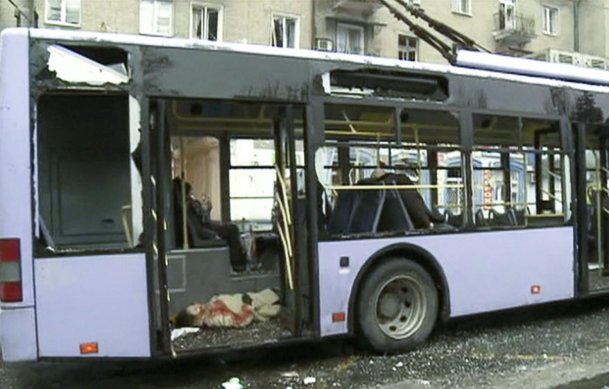 In this image made from the Russian RU-RTR television channel, passengers killed when a trolley bus was damaged after by a mortar shell in Donetsk, eastern Ukraine, Thursday, Jan. 22, 2015. It’s unclear which side was responsible for the attack, which killed passengers instantly and blew out the windows of a nearby building. A separatist defense official blames Ukrainian government forces. (AP Photo/ RU-RTR Russian Television Channel) TV OUT