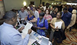 In this photo taken Wednesday, Oct. 22, 2014, Russell Neal, left, gives job information to job seeker Queena Moise, foreground second from right, at a job fair in Miami Lakes, Fla. The U.S. Labor Department reports on the number of people who applied for unemployment benefits the week ending Jan. 17, 2015 on Thursday, Jan. 22, 2015. (AP Photo/Alan Diaz) **FILE**
