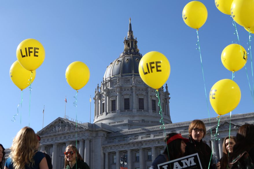 Members of the St. Rose of Lima Parish of Paso Robles Calif. arrive to the "Walk for Life" rally and march in San Francisco on Saturday, Jan. 24, 2015. Thousands of abortion opponents gathered at Civic Center Plaza in front of City Hall for the 11th annual event before marching down Market Street to Justin Herman Plaza. (AP Photo/Alex Washburn)