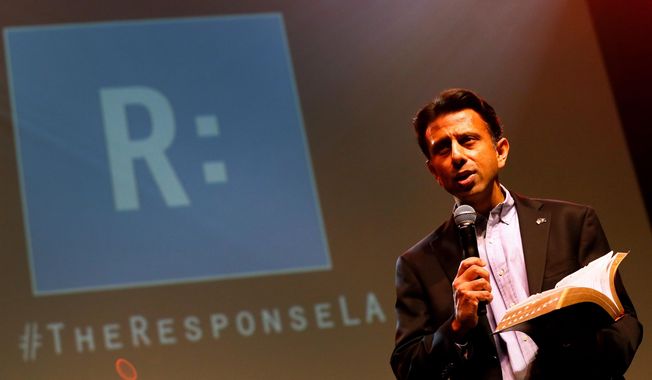 Louisiana Gov. Bobby Jindal reads from the bible during a prayer rally, Saturday, Jan. 24, 2015, in Baton Rouge, La. Mr. Jindal continued to court Christian conservatives for a possible presidential campaign with a headlining appearance at an all-day prayer rally hosted by the American Family Association. (AP Photo/Jonathan Bachman)