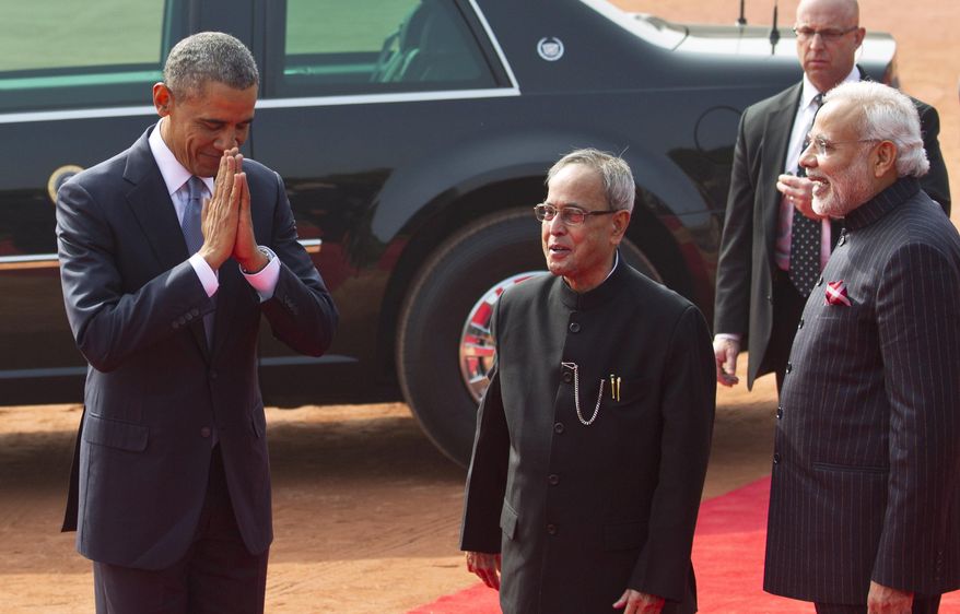 U.S. President Barack Obama folds his hands in a traditional Indian greeting gesture, as Indian President Pranab Mukherjee, center, and Prime Minister Narendra Modi laugh during a ceremonial reception at the Indian presidential Palace in New Delhi, India, Sunday, Jan. 25, 2015. Obama is the first American leader to be invited to attend India's Republic Day festivities, which commence Monday and mark the anniversary of the enactment of the country's democratic constitution. (AP Photo/Saurabh Das)