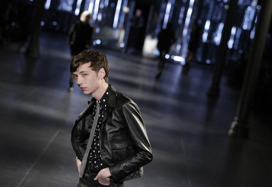 A model wears a creation for Saint Laurent's men's fall-winter 2015/2016 fashion collection presented in Paris, France, Sunday, Jan. 25, 2015. (AP Photo/Christophe Ena)