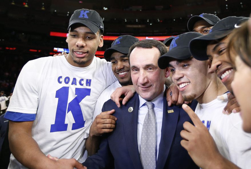 Duke head coach Mike Krzyzewski, center, celebrates with his players after his 1,000th career win in an NCAA college basketball game against St. John's at Madison Square Garden in New York, Sunday, Jan. 25, 2015. Krzyzewski became the first men's coach in Division I history with 1,000 wins. (AP Photo/Kathy Willens)