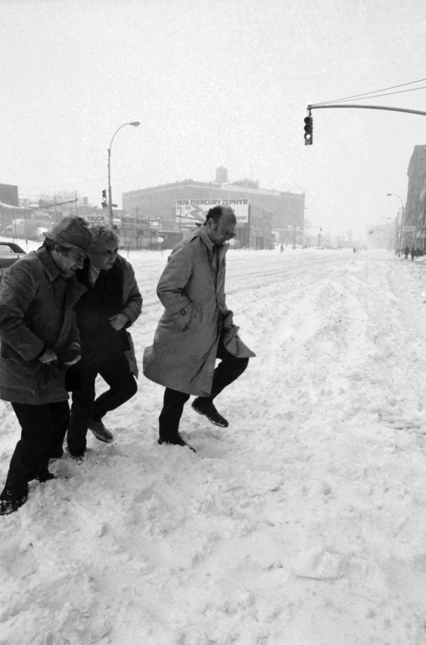 FILE - In this Jan. 20, 1978 file photo, New York City Mayor Ed Koch, right, accompanied by unidentified aides, steps through snow in queens during a tour of New York, to see first hand the conditions brought about by the city's worst storm of the decade. (AP Photo, File)