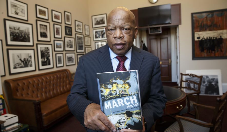 In this photo taken Jan. 15, 2015, Rep. John Lewis, D-Ga., holds the new installment of his award-winning graphic novel on civil rights and nonviolent protest, on Capitol Hill in Washington. A comic book about Martin Luther King Jr. helped bring John Lewis into the civil rights movement. The longtime Democratic congressman from Georgia now hopes that graphic novels about his life and what his contemporaries endured to overcome racism will guide today's protesters in search of justice. (AP Photo/J. Scott Applewhite)