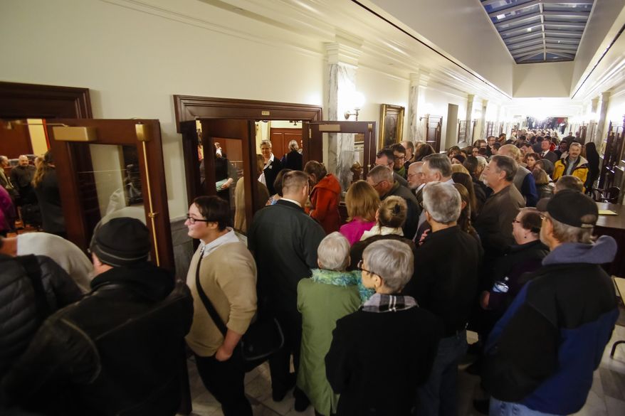 Hundreds of people line up to attend or testify at the House State Affairs Committee hearing on a bill that would include sexual orientation and gender identity protections to the state's Human Rights Act, at the state Capitol building, Monday, Jan. 26, 2015, in Boise, Idaho. (AP Photo/Otto Kitsinger)