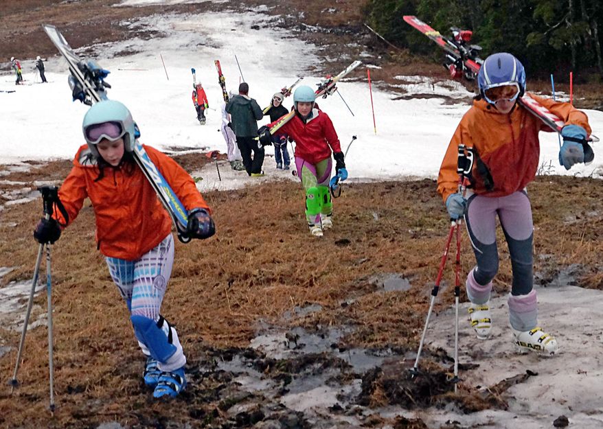 In this Sunday, Jan. 25, 2015, photo, Juneau Ski Team members hike up the slopes of Eaglecrest Ski Area after a practice ski on the small snow-covered portion of the course in Juneau, Alaska. The amount of moisture set a record for the month of January, when 11.29 inches of precipitation fell at the city's airport, the Juneau Empire reported. That broke the previous record of 10.16 inches, set just last year. (AP Photo/The Juneau Empire, Klas Stolpe)