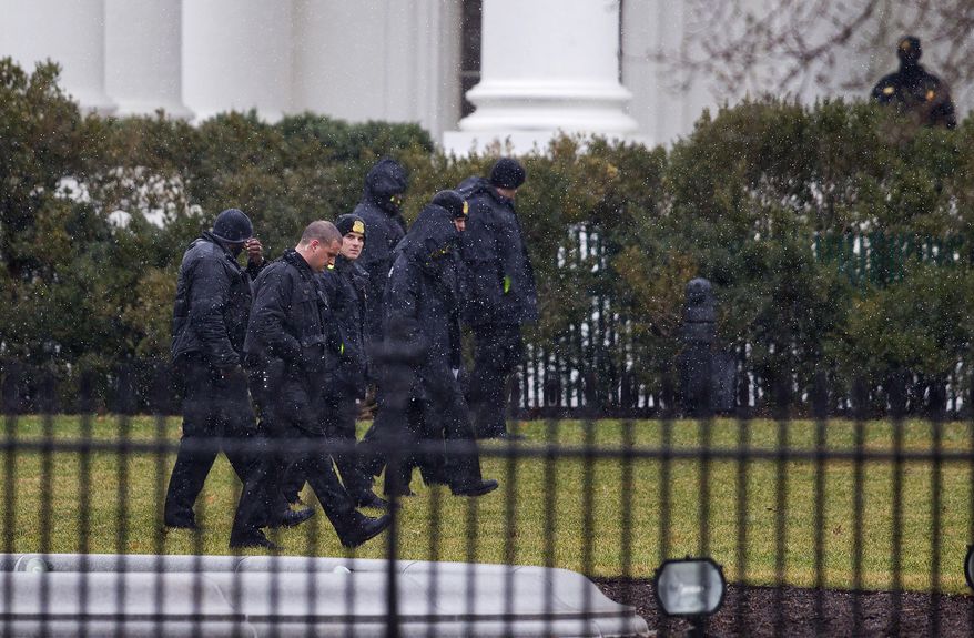Members of the Secret Service search the grounds of the North Lawn of the White House in Washington, Monday, Jan. 26, 2015. A device, possibly an unmanned aerial drone, was found on the White House grounds during the middle of the night while President Barack Obama and first lady were in India. It was unclear whether their daughters, Sasha and Malia, were at home at the time of the incident with their grandmother, Marian Robinson. (AP Photo/Pablo Martinez Monsivais) **FILE**